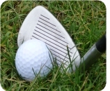 A golf ball beside an iron